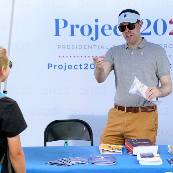 A leader from a conservative think tank talks to a fairgoer in Iowa.