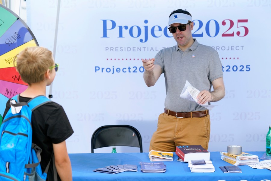 A leader from a conservative think tank talks to a fairgoer in Iowa.