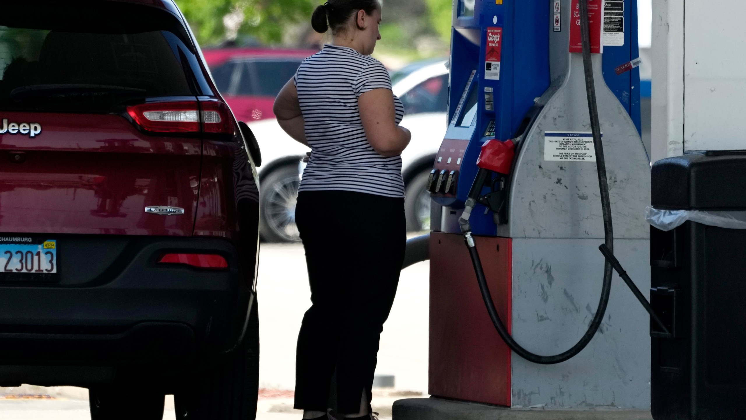 File - A customer prepares to pump gas at a filling station in Buffalo Grove, Ill., on May 10, 2023. On Thursday, the Commerce Department issues its July report on consumer spending. (AP Photo/Nam Y. Huh, File)