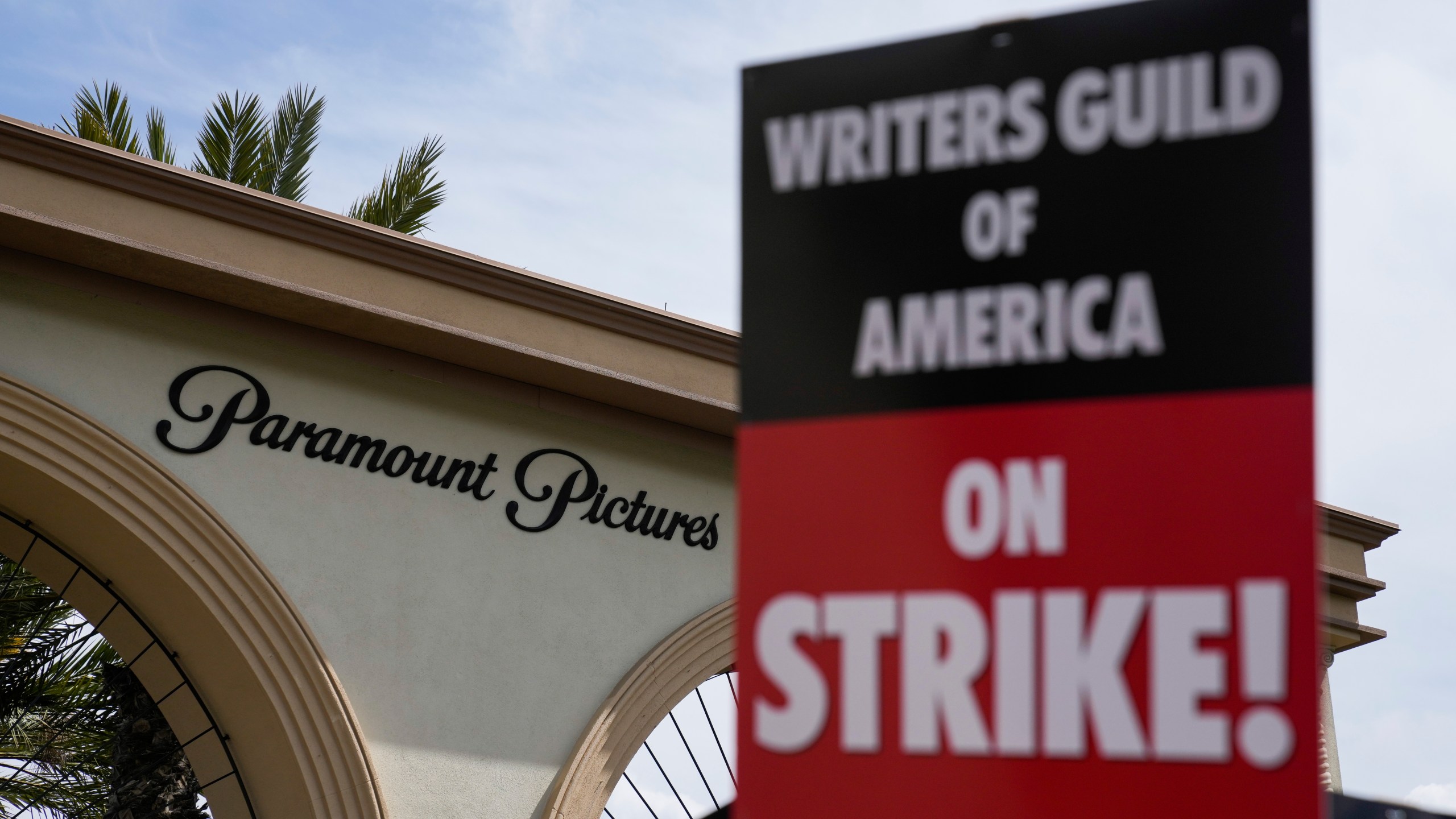 FILE - Members of the The Writers Guild of America picket outside Paramount Pictures on May 3, 2023, in Los Angeles. Hollywood productions and promotional tours around the world have been put on indefinite hold as actors and writers are on strike against big studios and streaming services.(AP Photo/Ashley Landis)