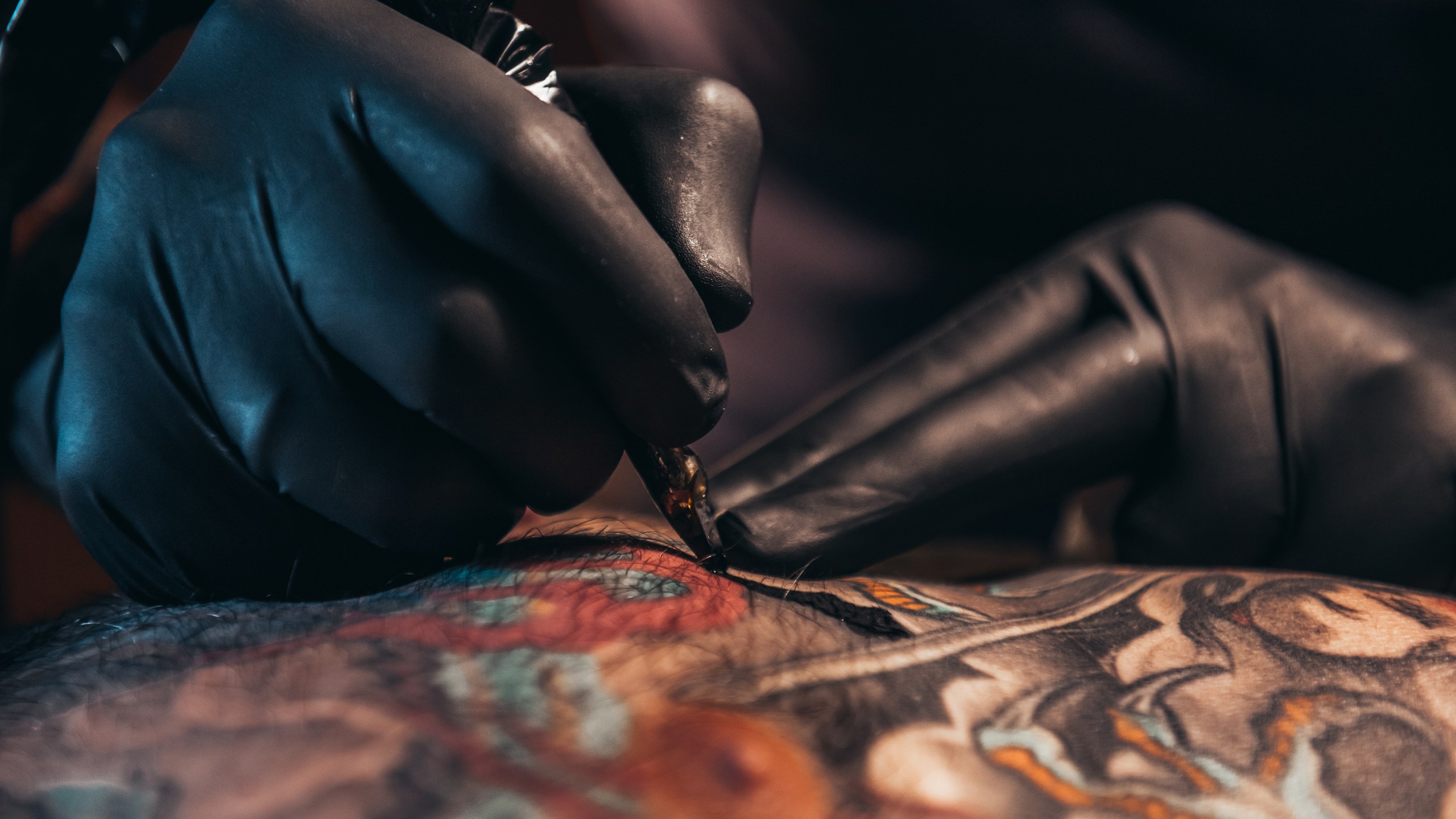 A tattoo artist working on a design