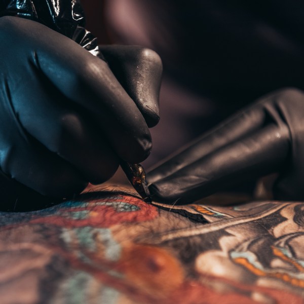 A tattoo artist working on a design
