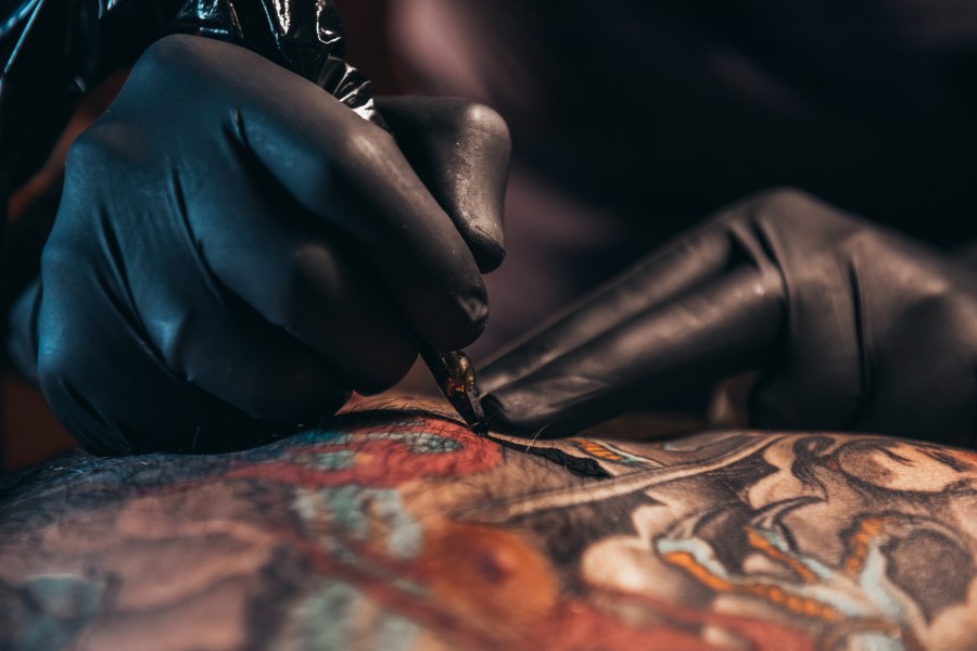 A tattoo artist working on a design