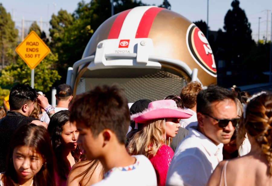 FILE - Fans wait to go through security before Taylor Swift performs at Levi's Stadium in Santa Clara, Calif., Friday, July 28, 2023. Fan frustration over getting tickets to Swift's tour prompted Congressional hearings and multiple bills in state legislatures. Consumer advocates in California say they are disappointed legislation in California has been watered down to solely banning hidden fees, a practice most major industry players have already committed to do. (Jessica Christian/San Francisco Chronicle via AP, File)/San Francisco Chronicle via AP)