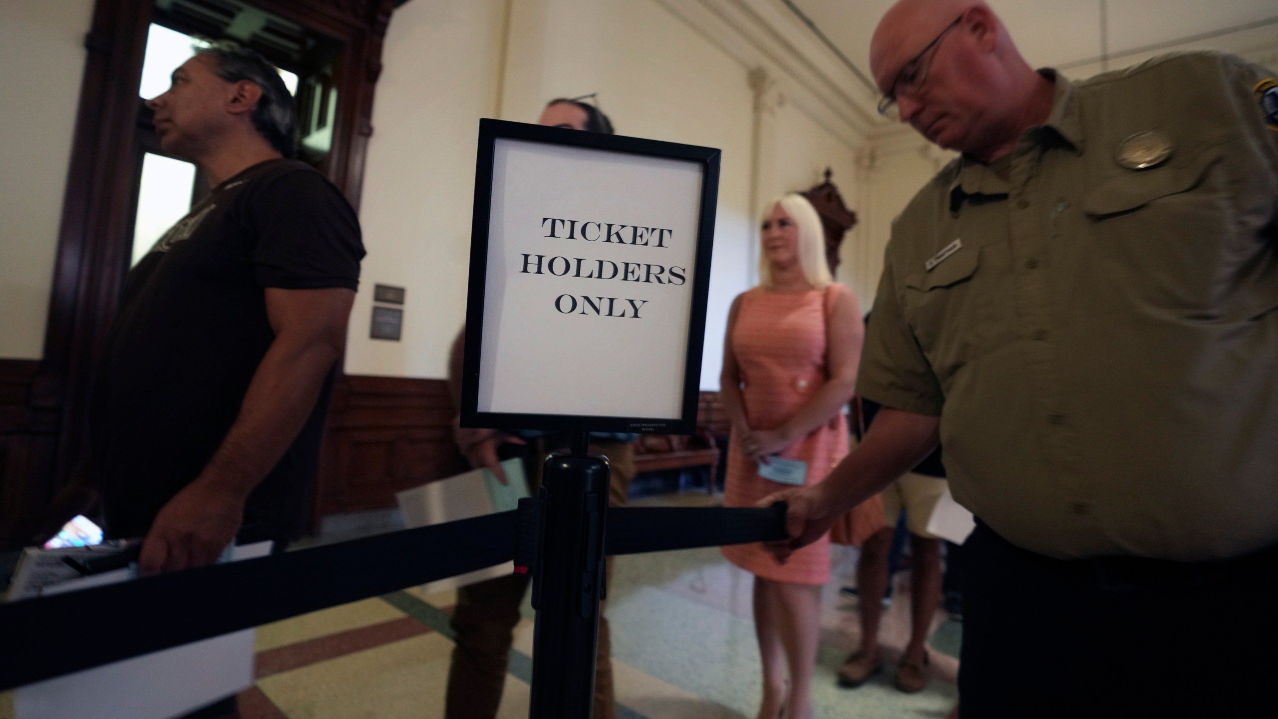 Ticketed members of the public line up outside the Texas State Senate Gallery waiting to enter to watch the impeachment trial of Texas Attorney General Ken Paxton in Austin, Tuesday, Sept. 5, 2023. (AP Photo/LM Otero)