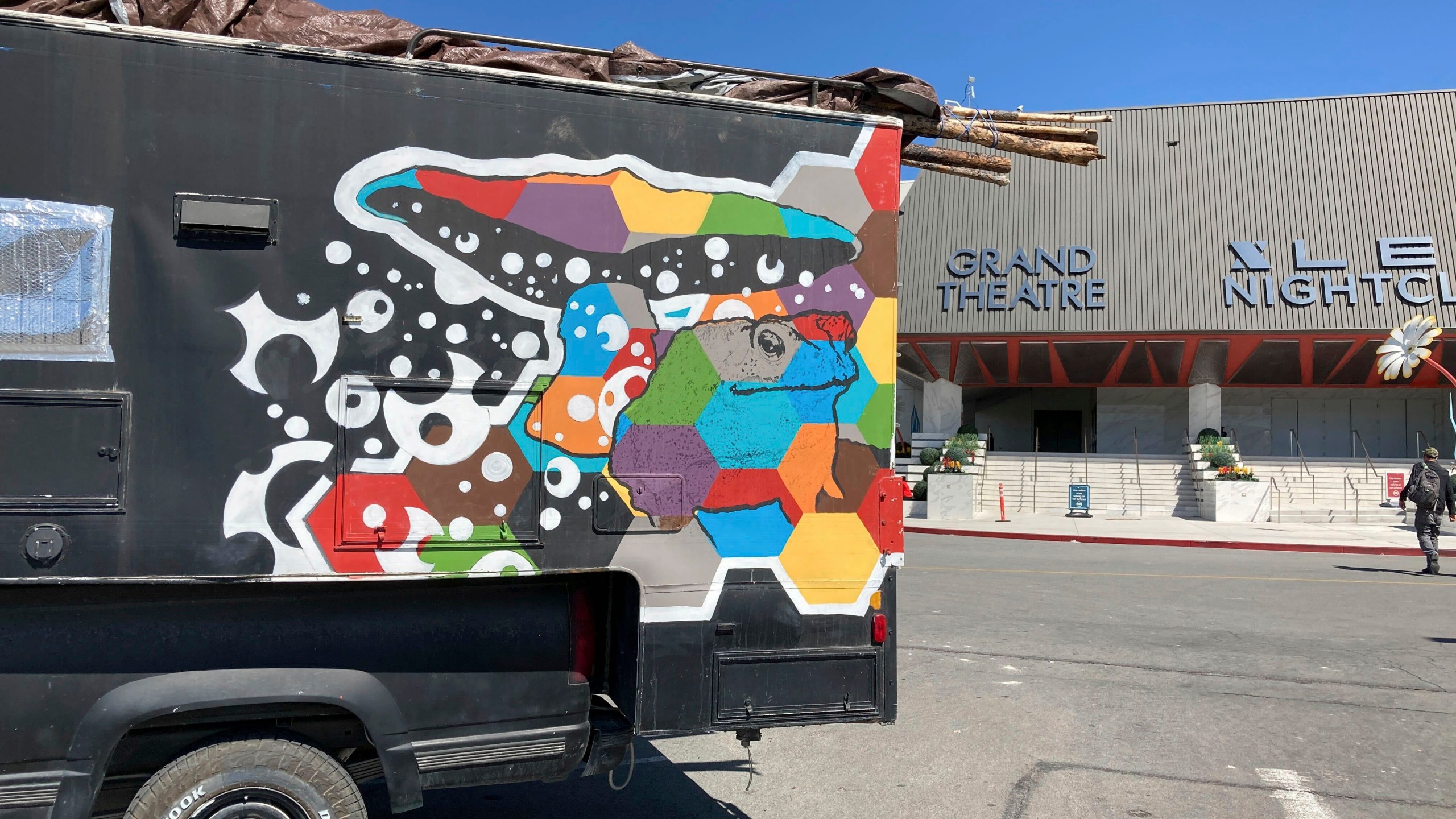 A painted vehicle sits in the Grand Sierra Resort and Casino parking lot in Reno, Nev., on Wednesday, Sept. 6, 2023. More than 100 RVs, campers and converted buses were parked Wednesday afternoon as the last of the Burning Man celebrants made their way journey back from the Black Rock Desert 100 miles to the north. (AP Photo/Scott Sonner)