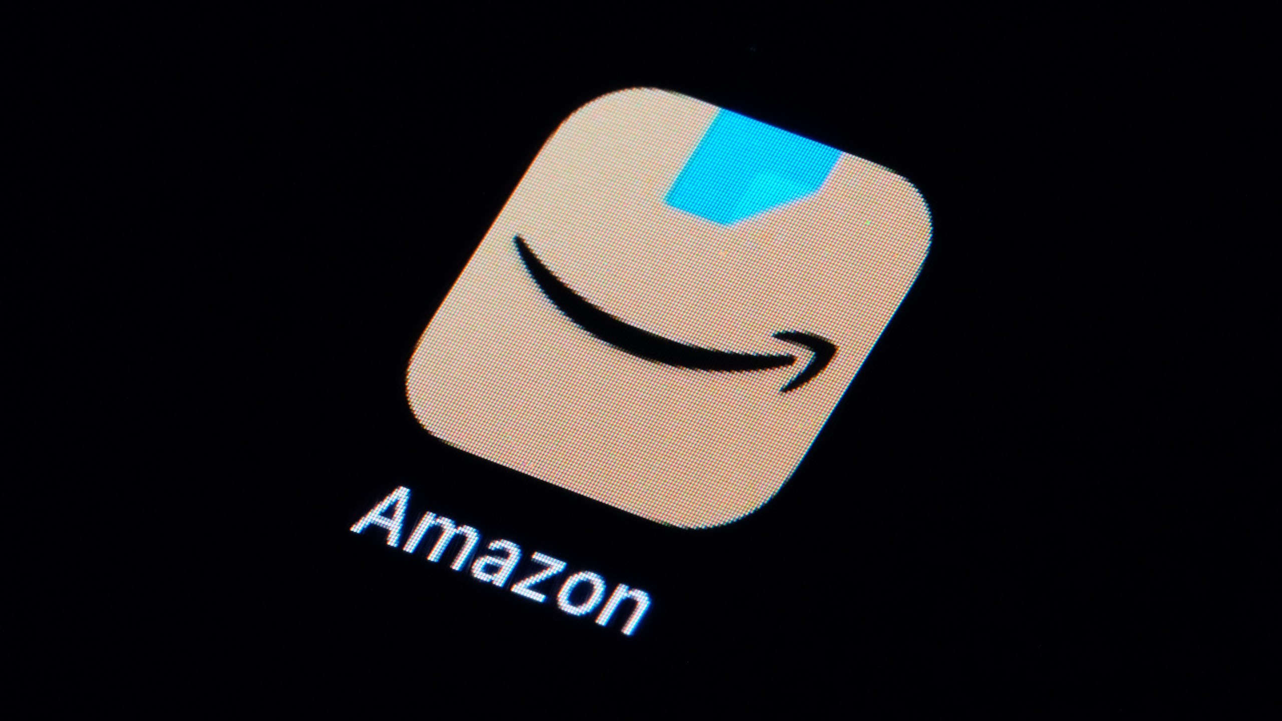 FILE - The Amazon app is seen on a smartphone, Tuesday, Feb. 28, 2023, in Marple Township, Pa. After months of complaints from the Authors Guild and other groups, Amazon.com started requiring writers who want to sell books through its e-book program to tell the company in advance that their work includes artificial intelligence material. (AP Photo/Matt Slocum, File)