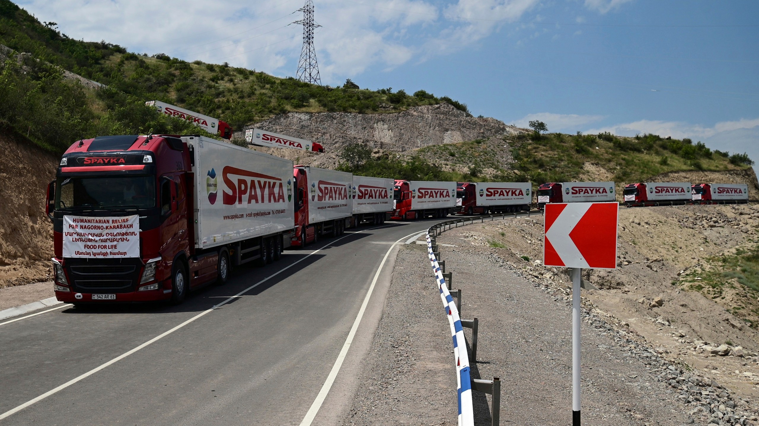 FILE - Trucks with humanitarian aid for Artsakh parked in a road towards the separatist region of Nagorno-Karabakh, in Armenia, on July 28, 2023. Armenia called on the U.N. Security Council to hold an emergency meeting on the worsening humanitarian situation in Azerbaijan’s Nagorno-Karabakh region, which is mostly populated by Armenians. In his letter to the president of the U.N. Security Council, sent Friday and released by Armenia’s Foreign Ministry on Saturday Aug. 12, 2023, Armenian U.N. ambassador Mher Margaryan said the people of Nagorno-Karabakh were “on the verge of a full-fledged humanitarian catastrophe.” (Hayk Manukyan/PHOTOLURE via AP, File)