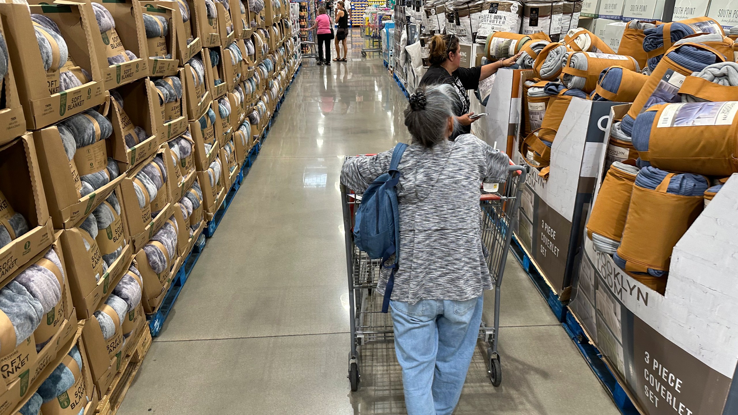 Shoppers look at blankets on sale in a Costco warehouse Thursday, Aug. 24, 2023, in Sheridan, Colo. On Wednesday, the Labor Department issues its consumer prices report for August. (AP Photo/David Zalubowski)