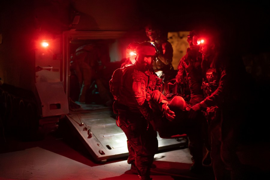 Ukrainian paramedics from 3rd Assault brigade carry on a stretcher their wounded comrade from an APC to the evacuation ambulance near Bakhmut, Donetsk region, Ukraine, Tuesday Sept. 12, 2023. (AP Photo/Alex Babenko)