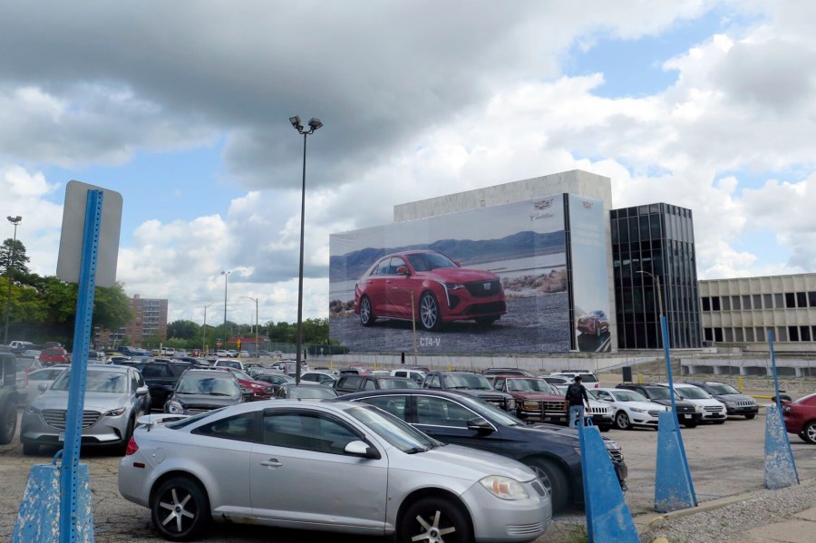 The cars of employees fill a parking lot at General Motor’s Lansing Grand River Assembly plant, Tuesday, Sept. 12, 2023, in Lansing, Mich., just days before auto workers could potentially strike due failed contract negotiations. (AP Photo/Joey Cappelletti)