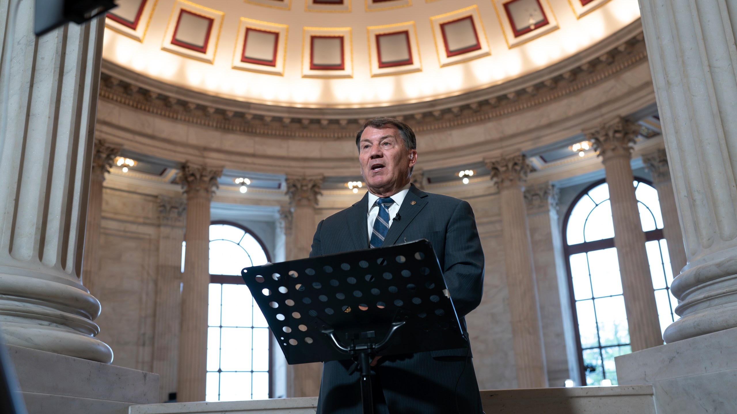 Sen. Mike Rounds, R-S.D., does a television news interview before joining Senate Majority Leader Chuck Schumer, D, N.Y., to convene a closed-door gathering of leading tech CEOs to discuss the priorities and risks surrounding artificial intelligence and how it should be regulated, at the Capitol in Washington, Wednesday, Sept. 13, 2023. (AP Photo/J. Scott Applewhite)