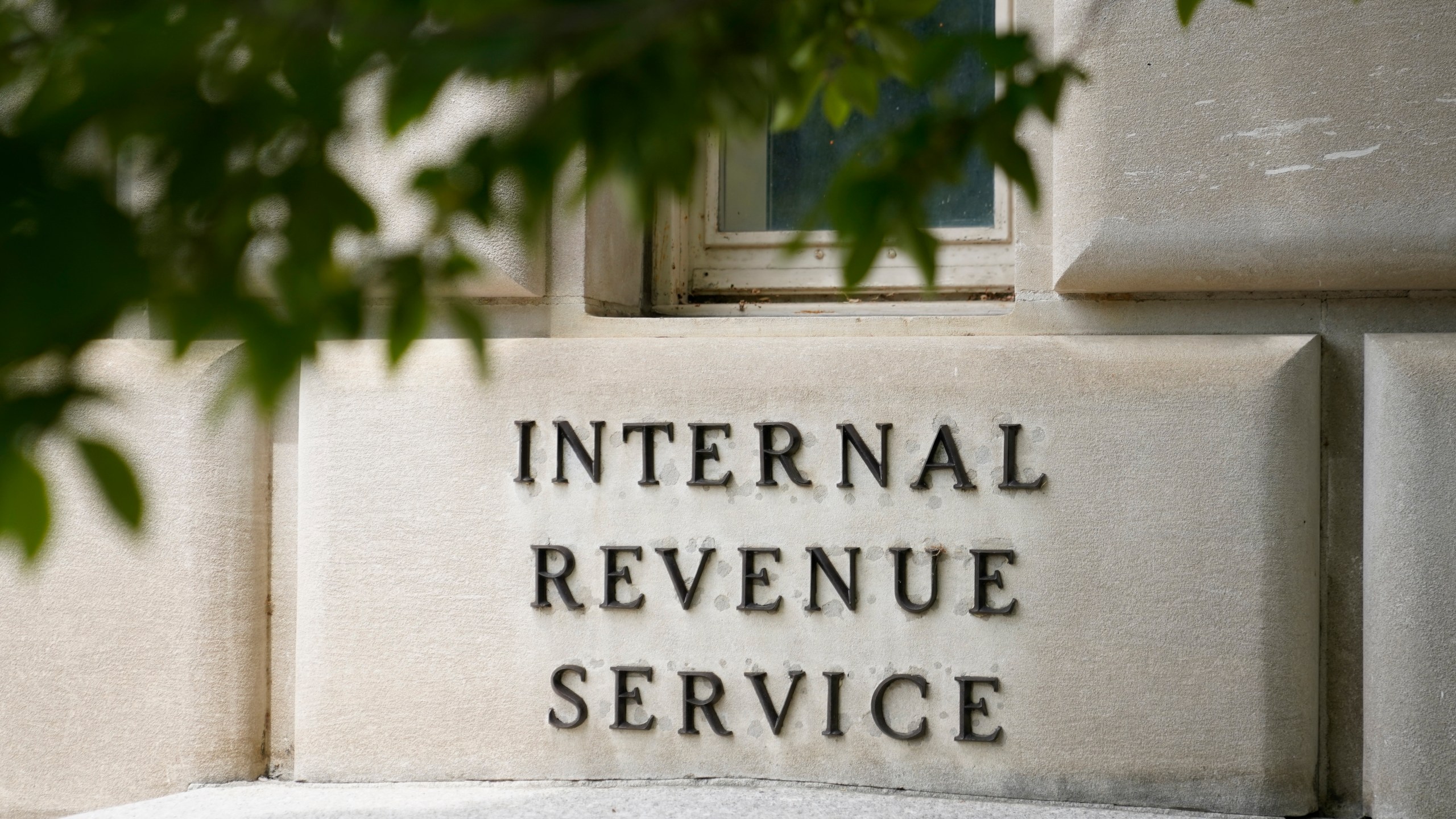 FILE - A sign outside the Internal Revenue Service building is seen, May 4, 2021, in Washington. The IRS is pausing accepting claims for the Employee Retention Credit, a pandemic-era tax credit, until 2024 due to rising concerns that an influx of applications are fraudulent. The IRS said Thursday, Sept. 14, 2023, that hundreds of criminal cases have been started and thousands of ERC claims have been referred for audit. (AP Photo/Patrick Semansky, File)