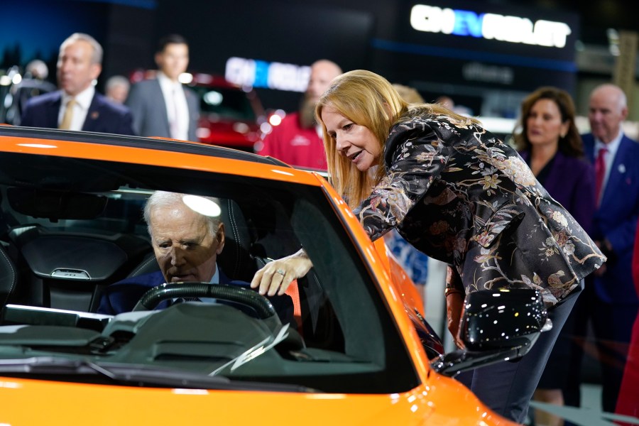 File - Mary Barra, CEO of General Motors, talks with President Joe Biden as he sits in a Corvette during a tour of the Detroit Auto Show on Sept. 14, 2022, in Detroit. United Auto Workers President Shawn Fain's focus on CEO pay is part of a growing trend as emboldened labor unions cite the widening wealth gap between workers and the top bosses to bolster their demand for higher wages and better working conditions. (AP Photo/Evan Vucci, File)