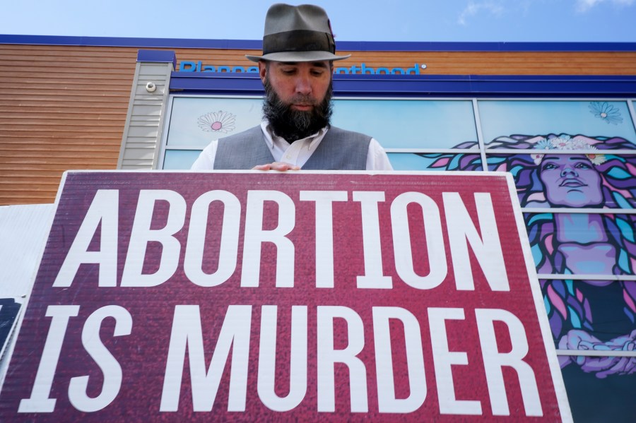 John Olkowski protests outside Planned Parenthood, Monday, Sept. 18, 2023, in Milwaukee. (AP Photo/Morry Gash)