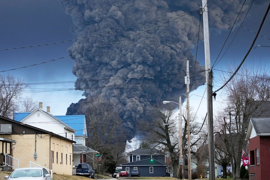 A black plume rises over East Palestine, Ohio, as a result of a controlled detonation of a portion of the derailed Norfolk Southern trains.