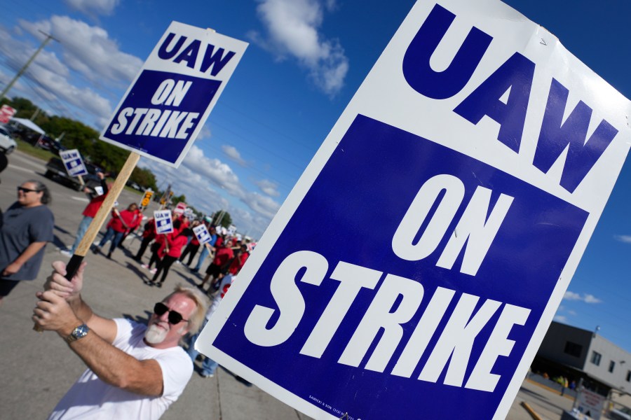 United Auto Workers members walk the picket line at the Ford Michigan Assembly Plant in Wayne, Mich., Monday, Sept. 18, 2023. So far the strike is limited to about 13,000 workers at three factories — one each at GM, Ford and Stellantis. (AP Photo/Paul Sancya)