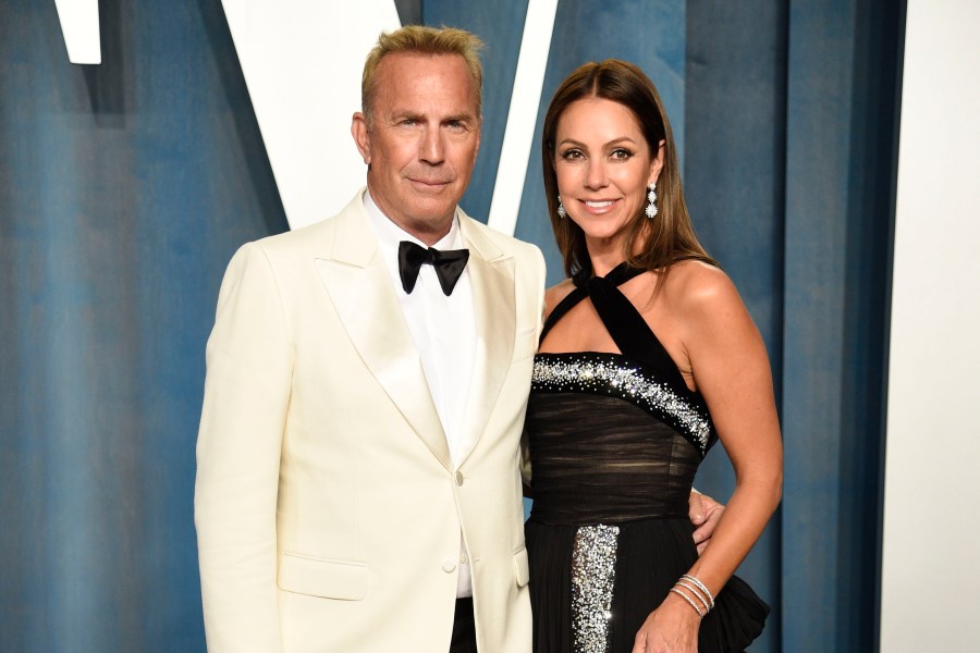 FILE - Kevin Costner, left, and Christine Baumgartner arrive at the Vanity Fair Oscar Party on March 27, 2022, in Beverly Hills, Calif. Costner and Baumgartner have reached a settlement in their divorce. The couple said in a joint statement that they have come to an amicable resolution to all the issues surrounding their split. (Photo by Evan Agostini/Invision/AP, File)