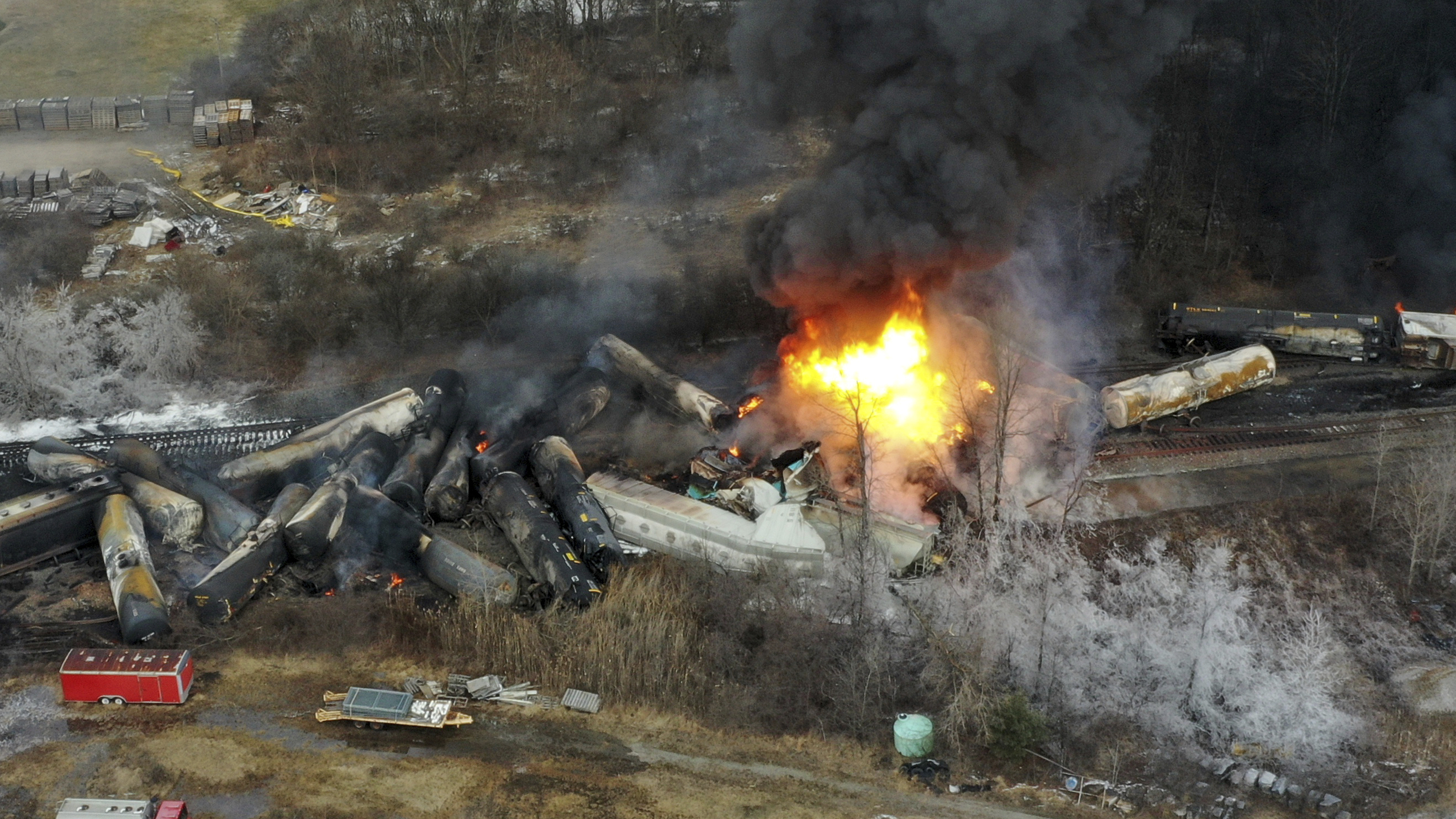 FILE - This photo taken with a drone shows portions of a Norfolk Southern freight train that derailed the night before in East Palestine, Ohio, still on fire at mid-day on Feb. 4, 2023. The railroad industry is trying to make sure that emergency responders can quickly look up what is on a train when they respond to a derailment. In the chaos after a Norfolk Southern train derailed and caught fire in eastern Ohio in February, firefighters couldn't find that information for roughly 45 minutes. (AP Photo/Gene J. Puskar, File)