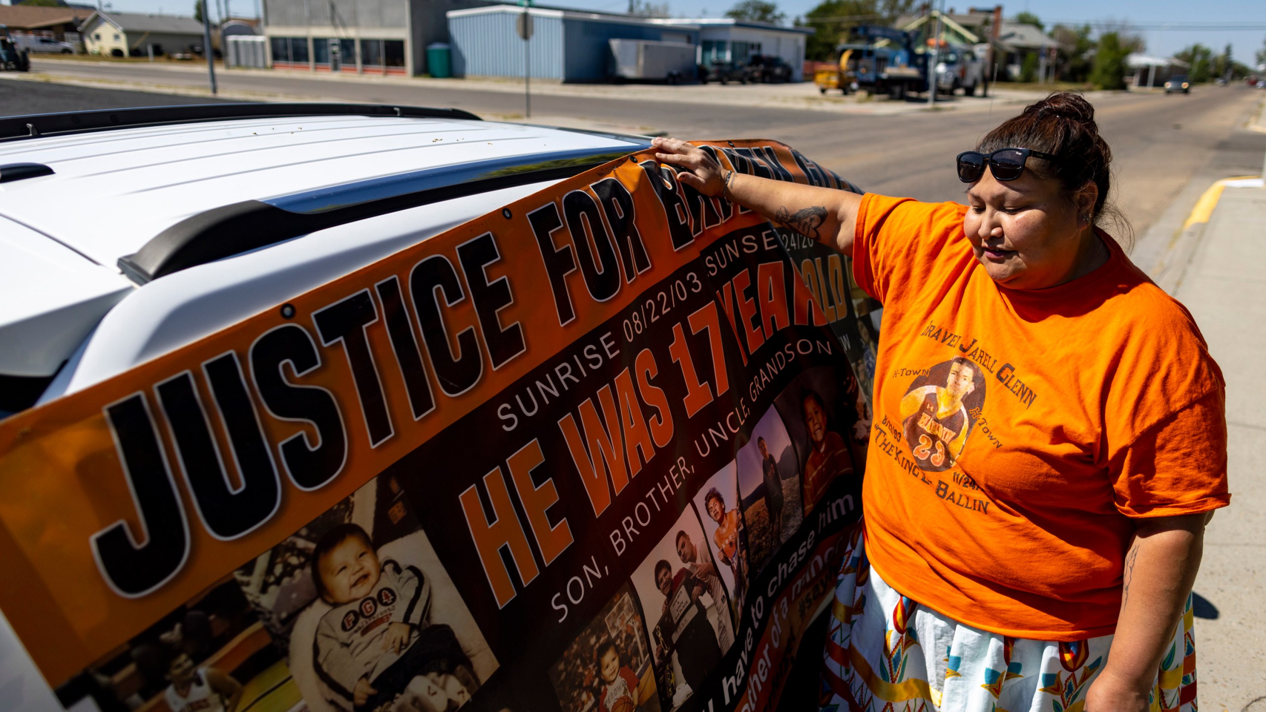 Blossom Old Bull holds up a banner for her son which says "justice for Braven Glenn," during a rally in support of the Missing and Murdered Indigenous People movement at the Big Horn County Building on Tuesday, Aug. 29, 2023, in Hardin, Mont. Glenn was killed while being pursued by a Crow Tribal Police officer. The Crow Tribal Police Department has since been disbanded and Old Bull has been critical of the amount of information she has received regarding the circumstances of her son's death. (AP Photo/Mike Clark)