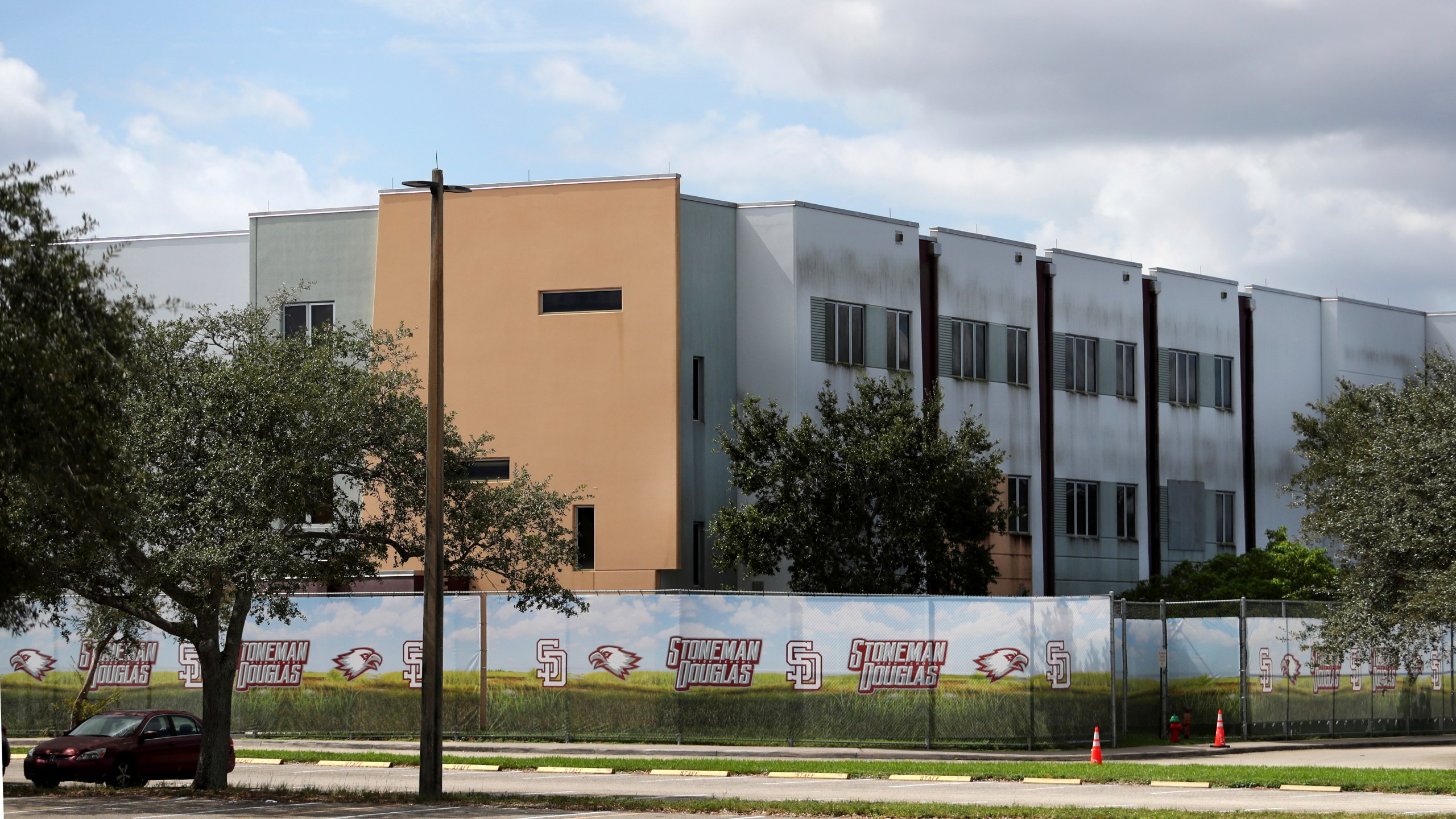 FILE - The 1200 building at Marjory Stoneman Douglas High School in Parkland, Fla., is seen, Oct. 20, 2021. The school building where 14 students and three staff members were fatally shot in a 2018 massacre is set to be demolished next summer, officials announced Thursday, Sept. 21, 2023. The demolition of Marjory Stoneman Douglas High School’s 1200 building, which has remained closed and locked behind a fence since the shooting, is scheduled to take place immediately following the conclusion of the school year. (Carline Jean/South Florida Sun-Sentinel via AP, File)