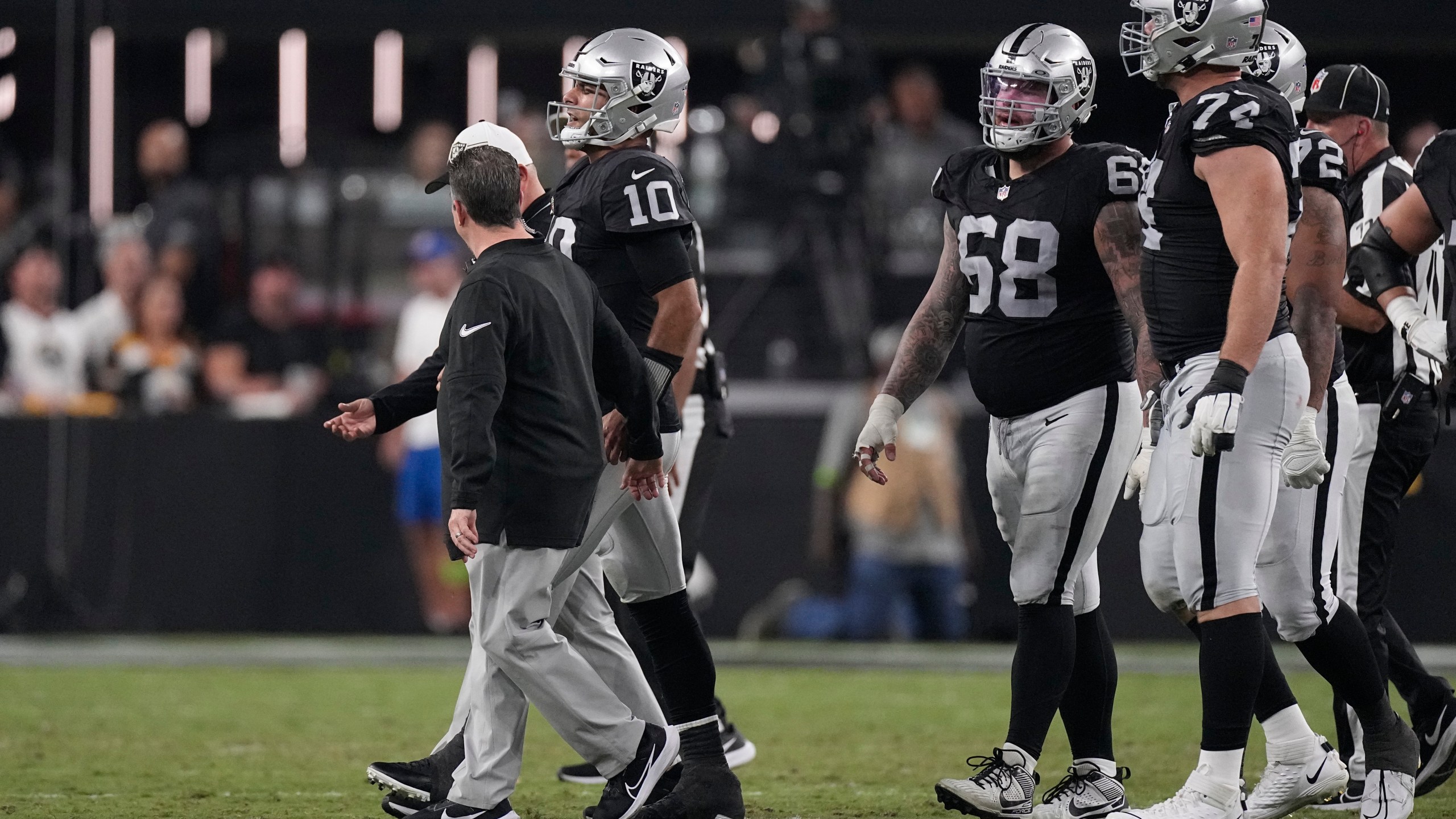 Las Vegas Raiders quarterback Jimmy Garoppolo is helped off the field after being sacked by Pittsburgh Steelers linebacker T.J. Watt during the first half of an NFL football game Sunday, Sept. 24, 2023, in Las Vegas. (AP Photo/Mark J. Terrill)