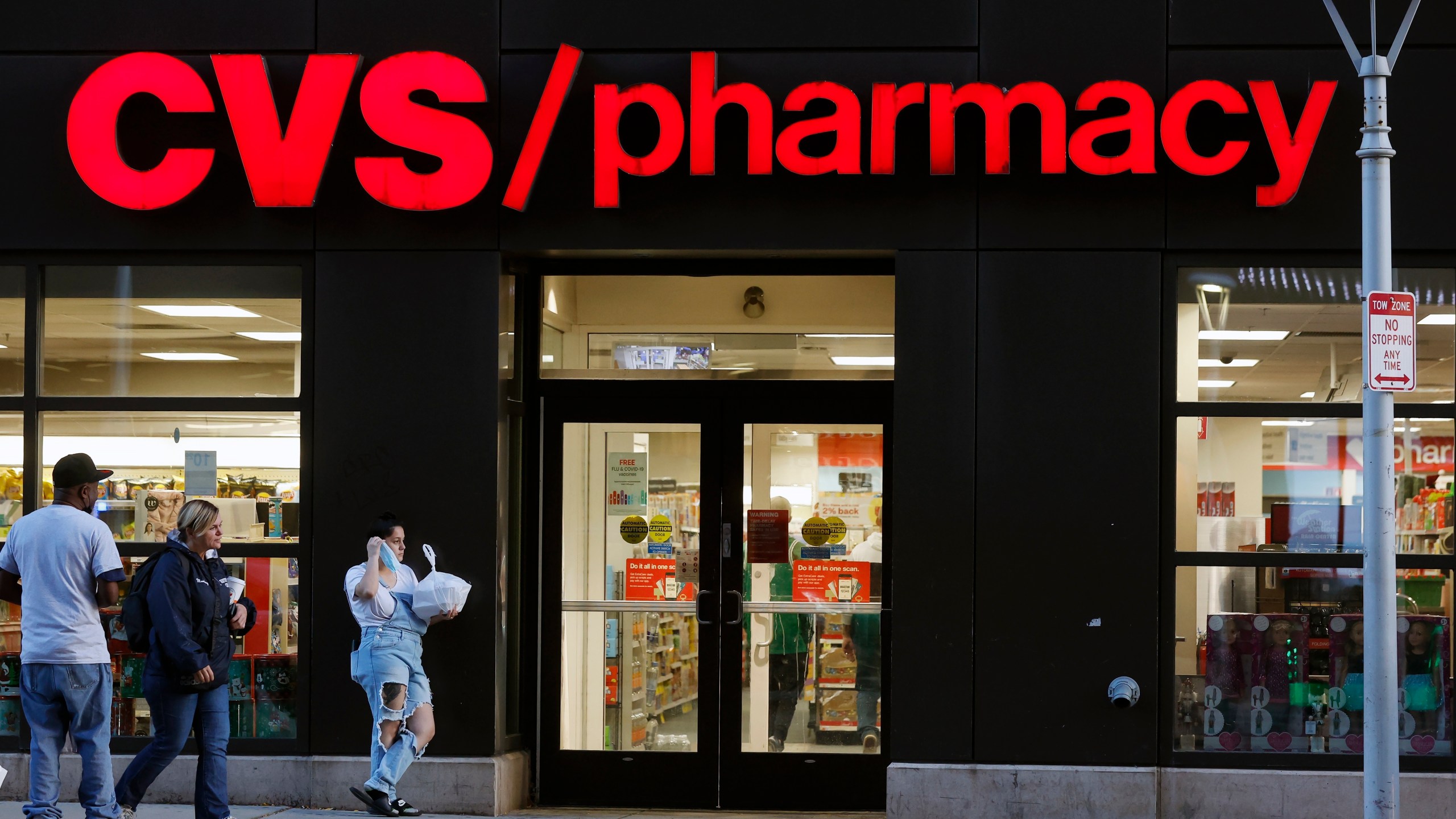 FILE - Customers walk to a CVS Pharmacy, Friday, Nov 4, 2022, in Boston. CVS made a move Wednesday, Sept. 27, 2023, to make frustrated pharmacists in the Kansas City-area to call off a walkout. It promised to boost hiring to ease overwhelming workloads that sometimes make it hard to take a bathroom break. (AP Photo/Michael Dwyer, FIle)