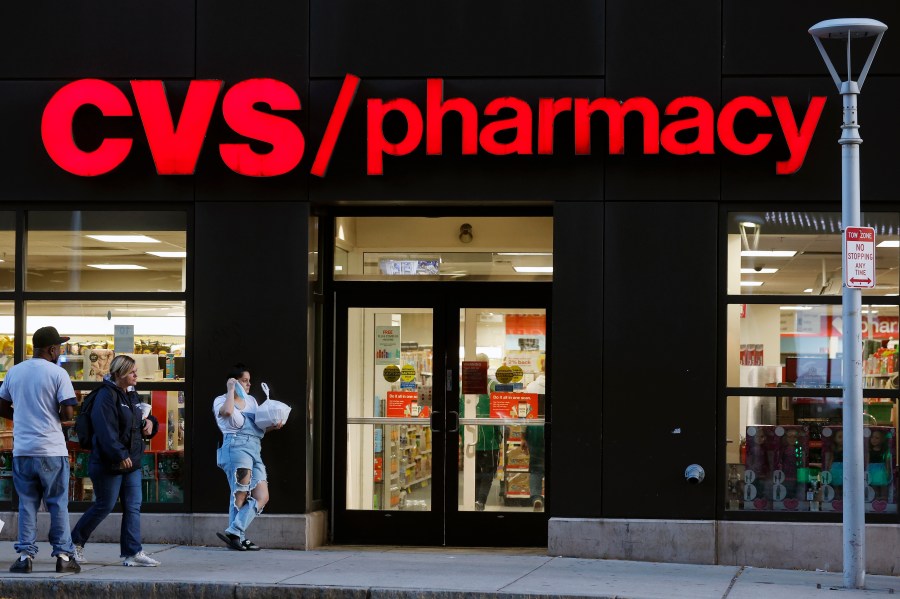 FILE - Customers walk to a CVS Pharmacy, Friday, Nov 4, 2022, in Boston. CVS made a move Wednesday, Sept. 27, 2023, to make frustrated pharmacists in the Kansas City-area to call off a walkout. It promised to boost hiring to ease overwhelming workloads that sometimes make it hard to take a bathroom break. (AP Photo/Michael Dwyer, FIle)