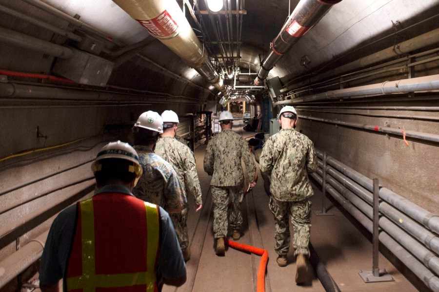 FILE - In this photo provided by the U.S. Navy, Rear Adm. John Korka, Commander, Naval Facilities Engineering Systems Command (NAVFAC), and Chief of Civil Engineers, leads Navy and civilian water quality recovery experts through the tunnels of the Red Hill Bulk Fuel Storage Facility, near Pearl Harbor, Hawaii, Dec. 23, 2021. On Thursday, Sept. 28, 2023, the Navy issued written reprimands to three now-retired military officers for their roles in the spill of jet fuel into Pearl Harbor's drinking water in 2021, but did not fire, suspend, dock the pay or reduce the rank of anyone for the incident. (Petty Officer 1st Class Luke McCall/U.S. Navy via AP, File)