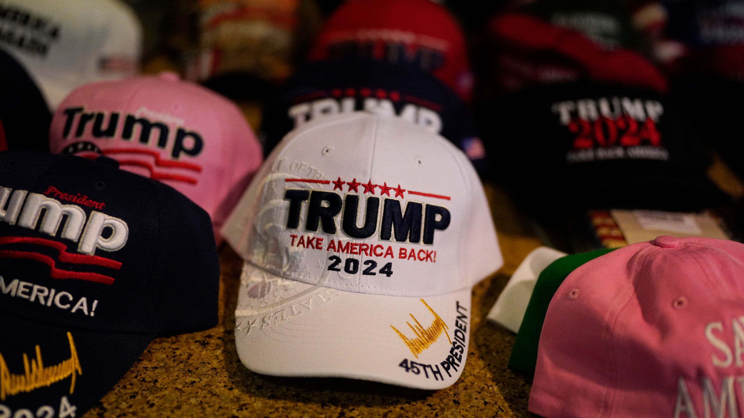 Hats with campaign slogans are sold before a speech by former President Donald Trump at the California Republican Party Convention, Friday, Sept. 29, 2023, in Anaheim, Calif. (AP Photo/Jae C. Hong)