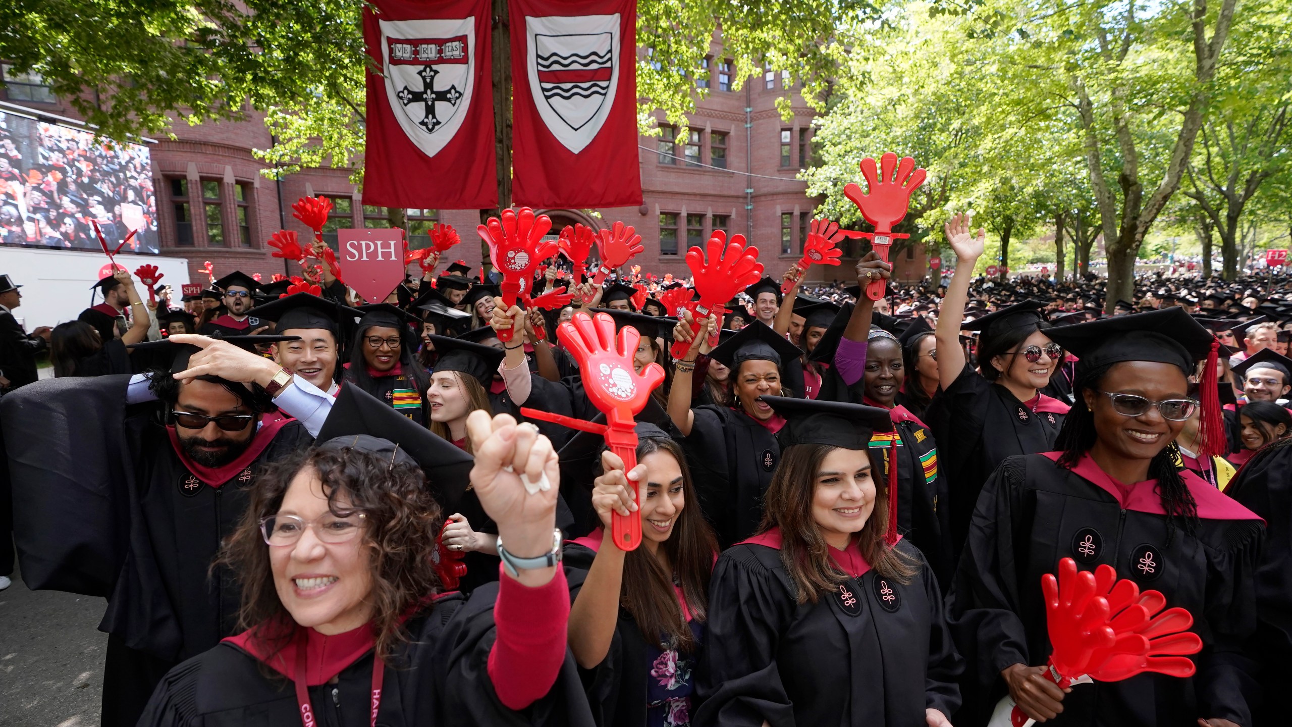 File - Graduating Harvard University students celebrate their degrees during commencement ceremonies, on May 25, 2023 in Cambridge, Mass. Student loan payments resume in October after a three-year pause due to the pandemic. (AP Photo/Steven Senne, File. )