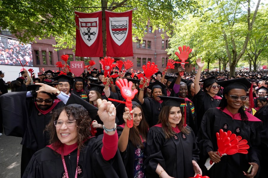 File - Graduating Harvard University students celebrate their degrees during commencement ceremonies, on May 25, 2023 in Cambridge, Mass. Student loan payments resume in October after a three-year pause due to the pandemic. (AP Photo/Steven Senne, File. )