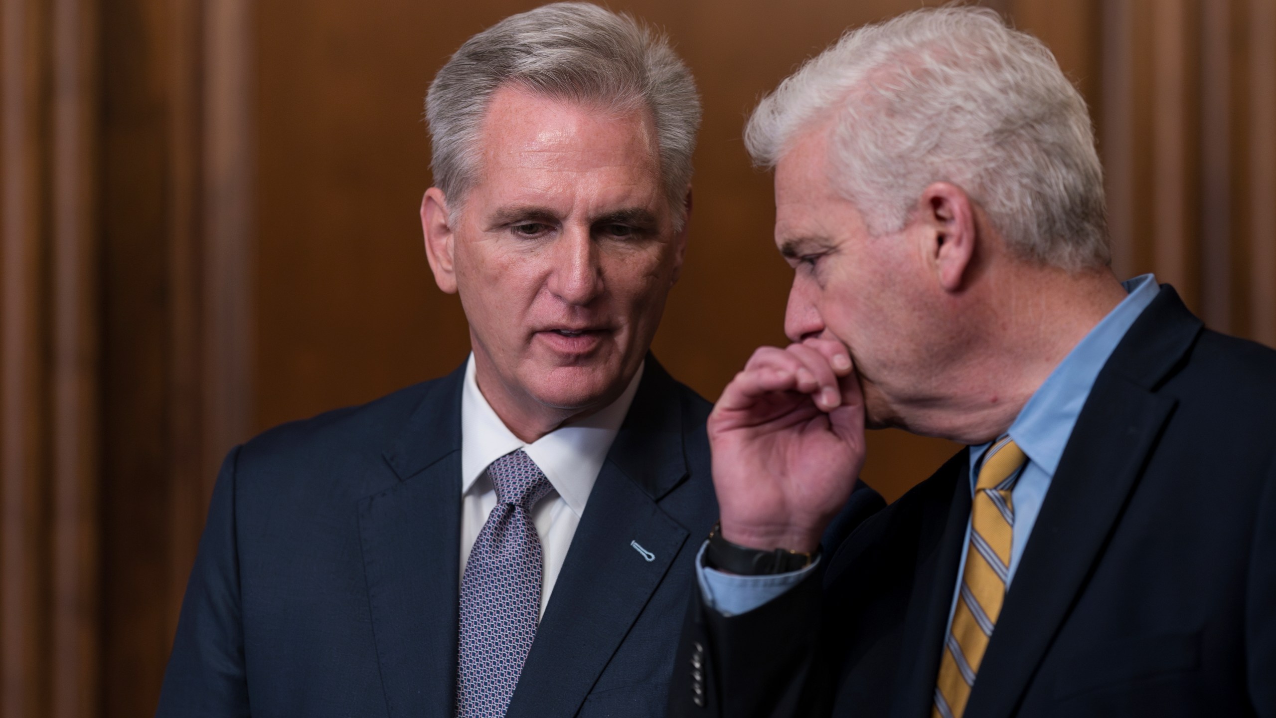 Speaker of the House Kevin McCarthy, R-Calif., confers with Majority Whip Tom Emmer, R-Minn., right, just after the House approved a 45-day funding bill to keep federal agencies open, but the measure must first go to the Senate, at the Capitol in Washington, Saturday, Sept. 30, 2023. (AP Photo/J. Scott Applewhite)