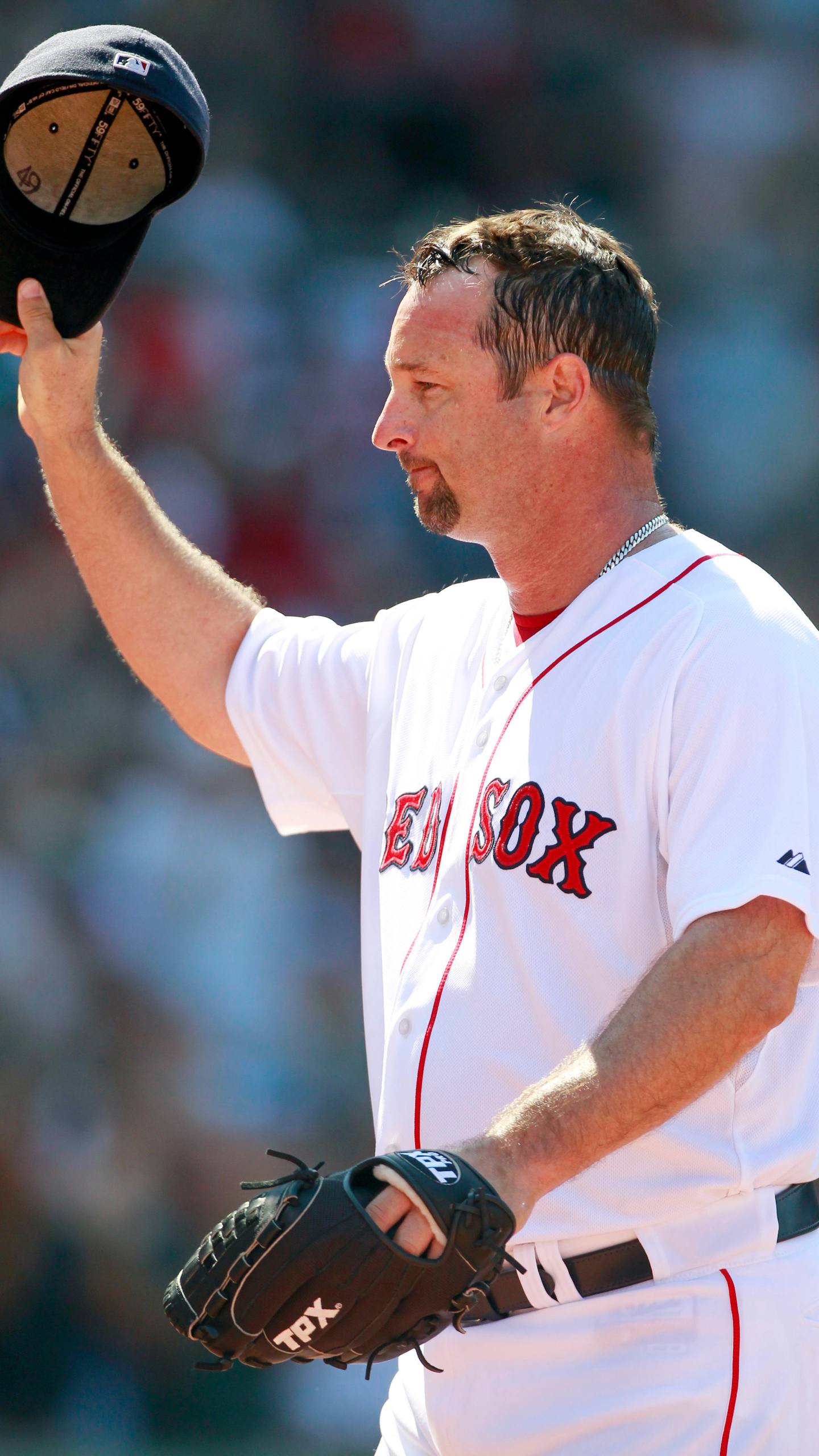 FILE - Boston Red Sox's Tim Wakefield tips his cap as he comes off the field in the sixth inning of a baseball game against the Seattle Mariners in Boston, July 24, 2011. Wakefield, the knuckleballing workhorse of the Red Sox pitching staff who bounced back after giving up a season-ending home run to the Yankees in the 2003 playoffs to help Boston win its curse-busting World Series title the following year, has died. He was 57. The Red Sox announced his death in a statement Sunday, Oct. 1 2023, (AP Photo/Michael Dwyer, file)