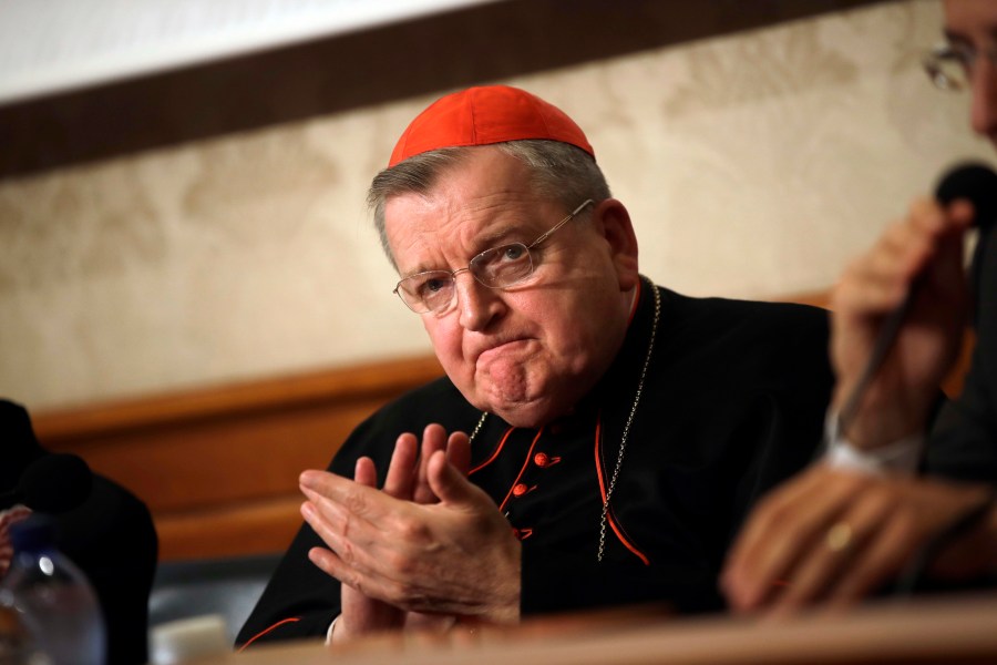 FILE - In this Sept. 6, 2018 file photo, Cardinal Raymond Burke applauds during a news conference at the Italian Senate, in Rome. Five conservative cardinals are challenging Pope Francis to affirm Catholic teaching on homosexuality and female ordination. They've asked him to respond ahead of a big Vatican meeting where such hot-button issues are up for debate. The cardinals on Monday published five questions they submitted to Francis, known as “dubia.” (AP Photo/Alessandra Tarantino, File)