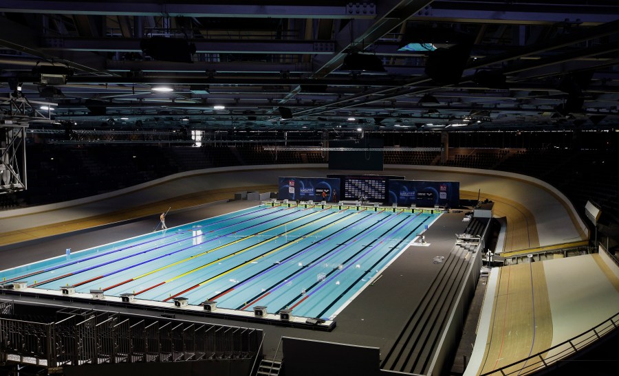 FILE - Workers put finishing touches on a pool for swimming events in Berlin, Germany, Aug. 11, 2014. Plans for the first “open category” swimming races to accommodate transgender competitors at a World Cup this weekend have been scrapped because of a lack of entries. World Aquatics said Tuesday, Oct. 3, 2023 it had received “no entries” for the open category events scheduled to take place at a World Cup starting Friday in Berlin. (AP Photo/Michael Sohn, file)