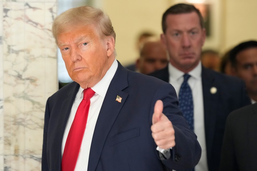 Former President Donald Trump motions to the media as he walks out of the courtroom during a break in his civil business fraud trial at New York Supreme Court, Tuesday, Oct. 3, 2023, in New York. Trump is in court for the second day of his trial. A day after fiery opening statements, lawyers in the case are moving Tuesday to the plodding task of going through years' worth of Trump's financial documents. (AP Photo/Seth Wenig)