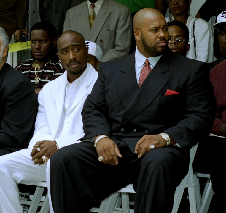 FILE - Rapper Tupac Shakur, left, and Death Row Records Chairman Marion "Suge" Knight, attend a voter registration event in South Central Los Angeles, August 15, 1996. Shakur's shooting in a New York recording studio in the mid-1990s sparked hip-hop's biggest rivalry and led to the shocking deaths of two of the genre's greatest stars. Shakur and Notorious B.I.G. were gunned down in drive-by shootings only six months apart. Nearly three decades later, the recent arrest of longtime suspect Duane “Keffe D” Davis has ignited another wave of intrigue in their unsolved murders. (AP Photo/Frank Wiese, File)