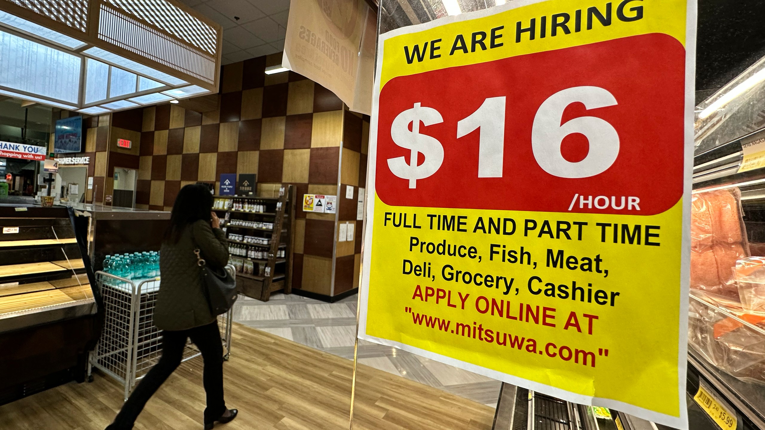 A hiring sign is displayed at a grocery store in Arlington Heights, Ill., Tuesday, Oct. 10, 2023. On Thursday, the Labor Department reports on the number of people who applied for unemployment benefits last week. (AP Photo/Nam Y. Huh)