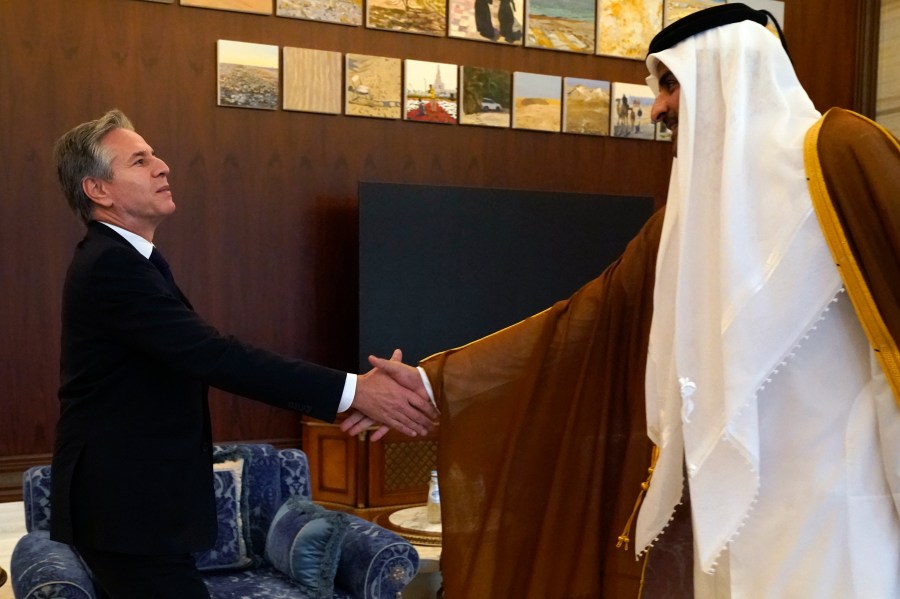 U.S. Secretary of State Antony Blinken, left, and Qatari Emir Sheikh Tamim bin Hamad Al Thani shake hands before their meeting in Lusail, Qatar, Friday Oct. 13, 2023. (AP Photo/Jacquelyn Martin, Pool)