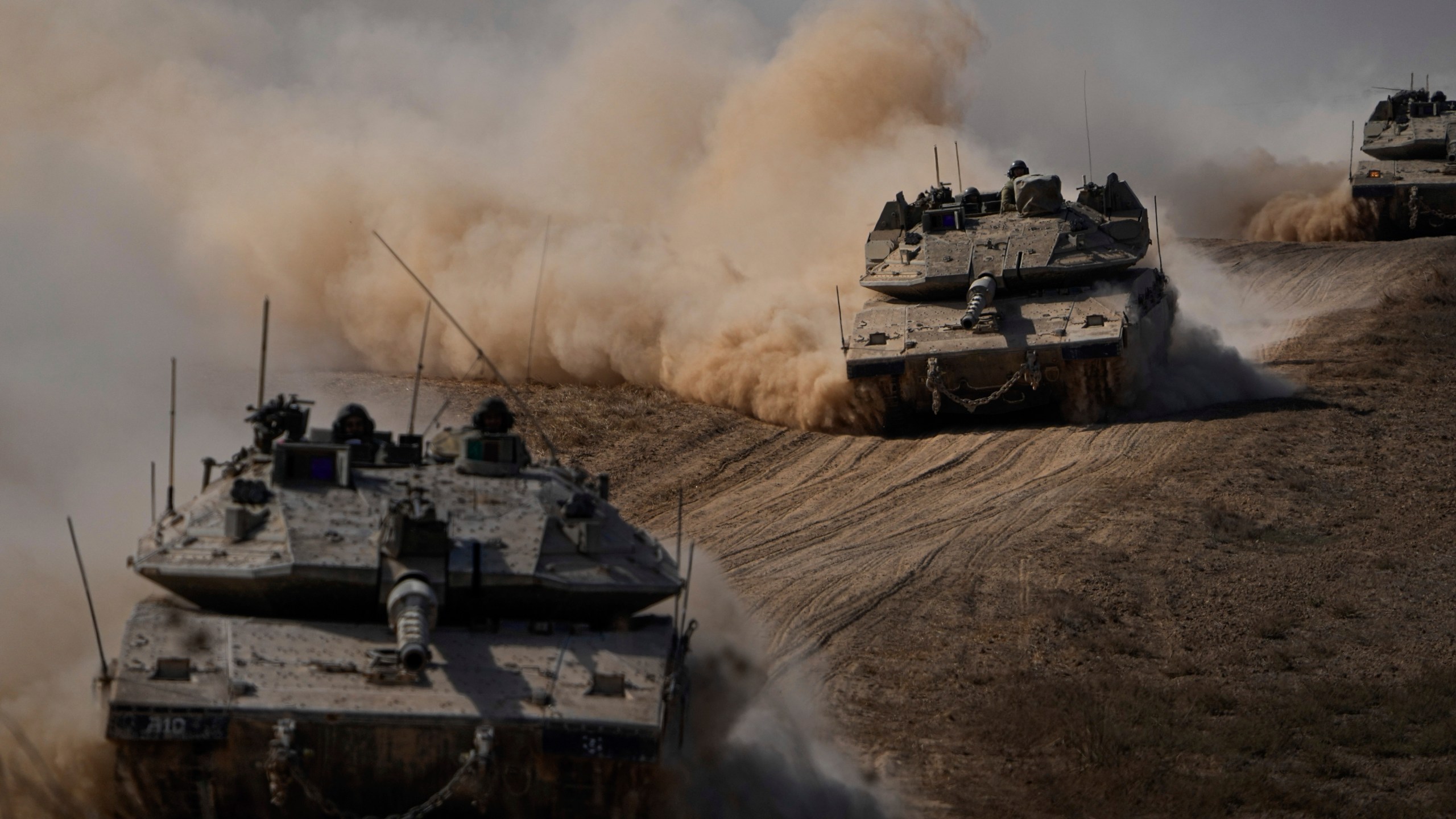 Israeli tanks head towards the Gaza Strip border in southern Israel on Friday, Oct.13, 2023. (AP Photo/Ariel Schalit)