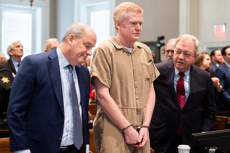 FILE - Alex Murdaugh speaks with his legal team before he is sentenced to two consecutive life sentences for the murder of his wife and son by Judge Clifton Newman at the Colleton County Courthouse on Friday, March 3, 2023 in in Walterboro, S.C. Murdaugh's lawyers have filed court papers that he plans to plead guilty in federal court to charges he stole money from clients. (Joshua Boucher/The State via AP, File, Pool)