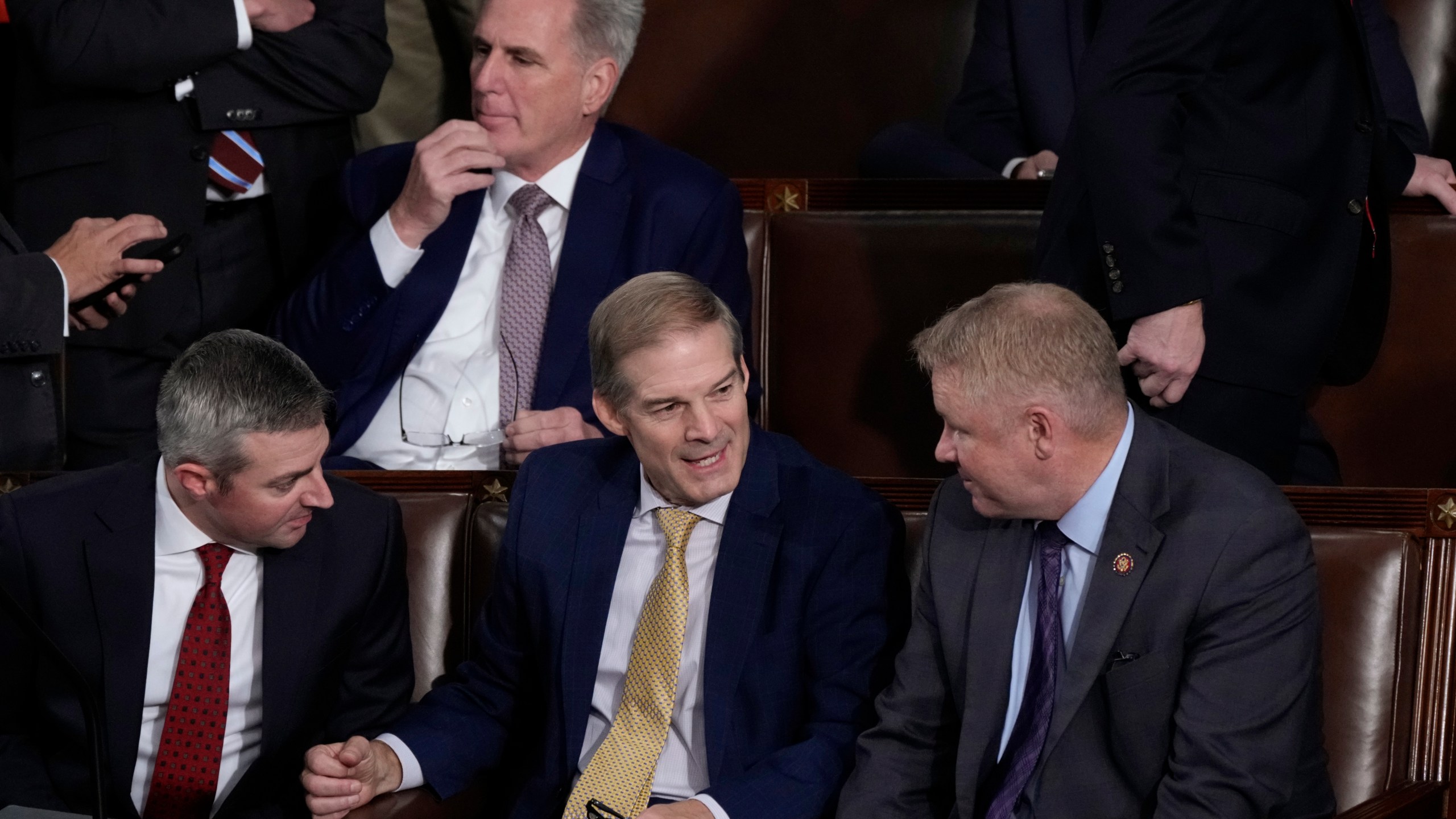 Rep. Jim Jordan, R-Ohio, chairman of the House Judiciary Committee, seated center, talks to Rep. Warren Davidson, R-Ohio, right, and a House staff member, left, as Republicans try to elect Jordan, a top Donald Trump ally, to be the new House speaker, at the Capitol in Washington, Tuesday, Oct. 17, 2023, as former Speaker of the House Rep. Kevin McCarthy, R-Calif., sits behind them. (AP Photo/J. Scott Applewhite)