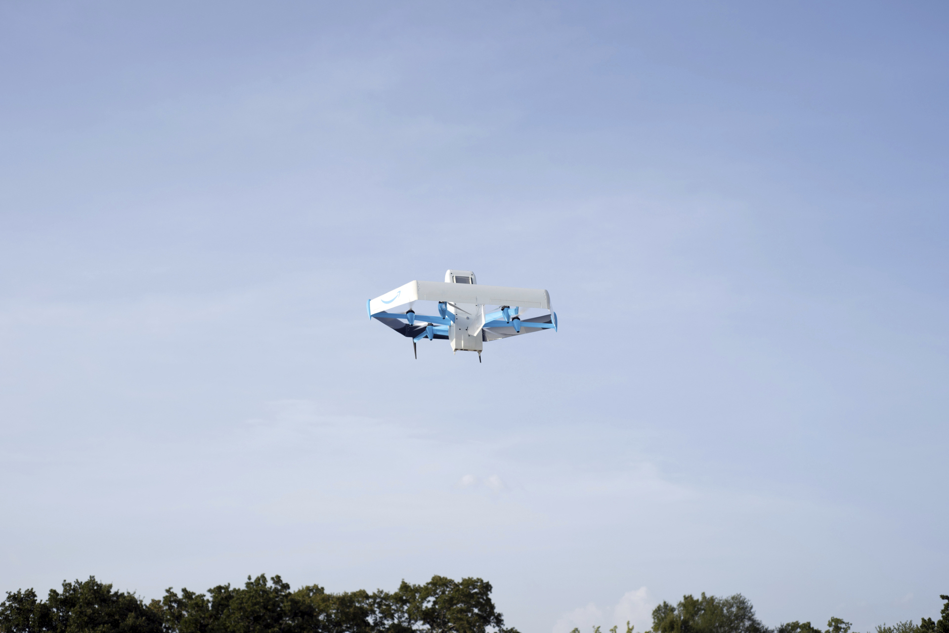 This photo provided by Amazon shows a drone delivering presciption drugs in College Station, Texas. Amazon will soon make prescription drugs fall from the sky when the e-commerce giant becomes the latest company to test drone deliveries for medications. The company said Wednesday, Oct. 18, 2023 that customers in College Station, Texas, can now get prescriptions delivered by a drone within an hour of placing their order. (Amazon via AP)