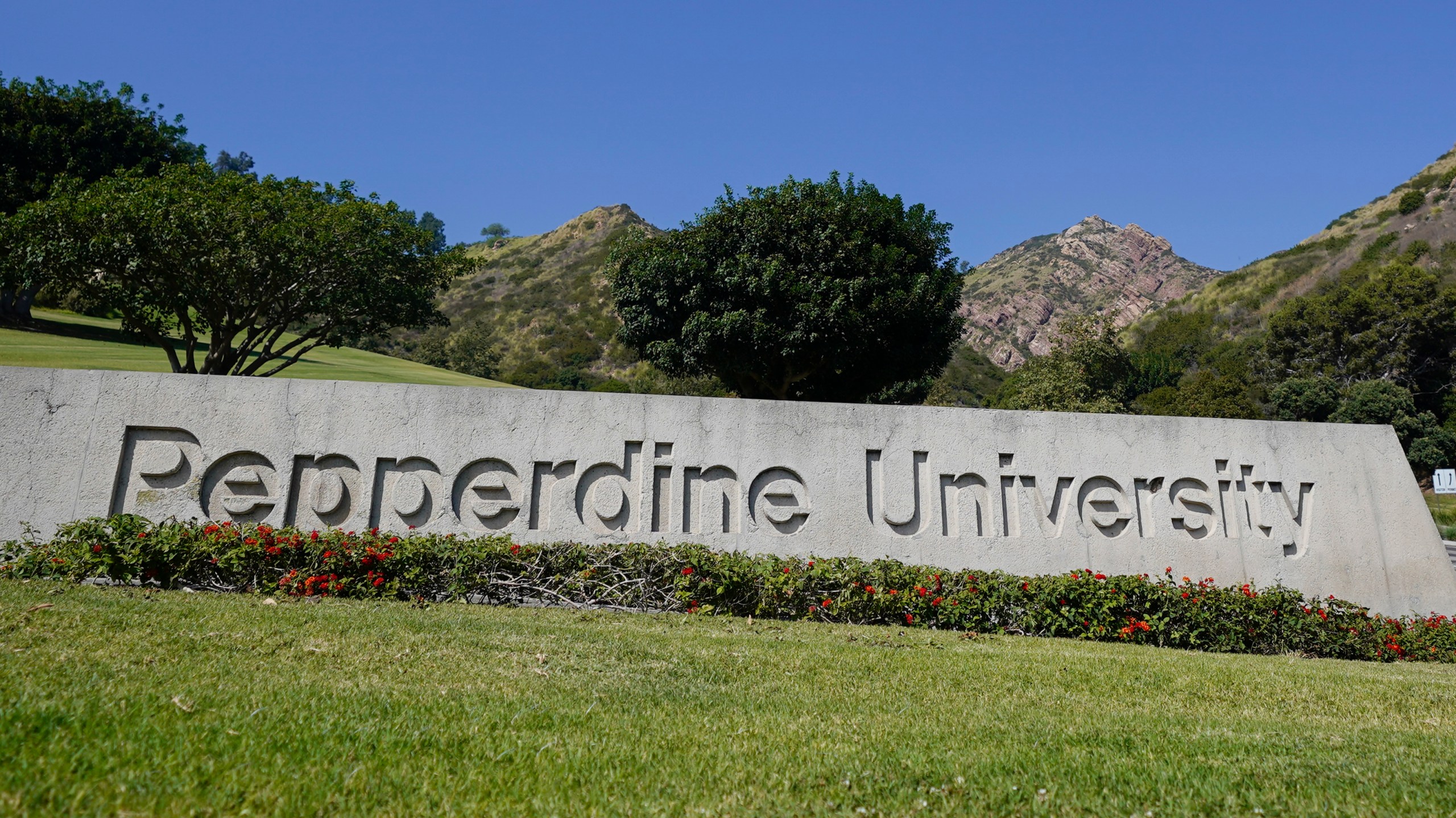 The entrance sign to Pepperdine University is seen Wednesday, Oct. 18, 2023, in Malibu, Calif. The Los Angeles County Fire Department says four people died after a multicar crash on the Pacific Coast Highway Tuesday at about 8:30 p.m. Four people were pronounced dead at the scene. Pepperdine University says there "is reason to believe" the four killed were students from its Seaver College of Liberal Arts. The cause of the crash is under investigation. (AP Photo/Ryan Sun)