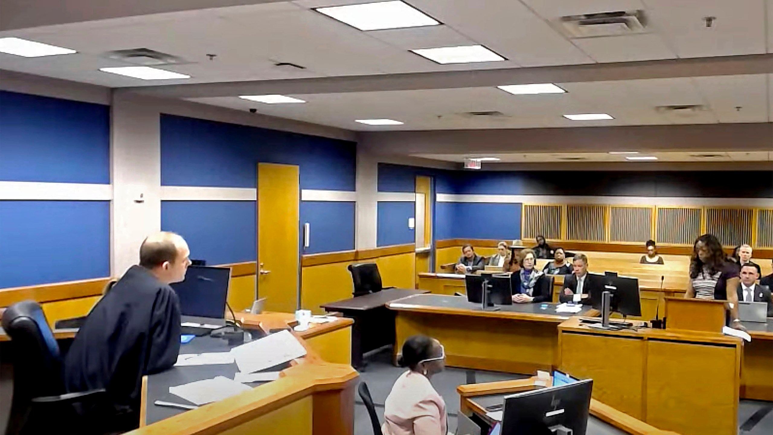 In this frame grab from video, Sidney Powell, former attorney for former President Donald Trump, attends a hearing with her attorney Brian Rafferty before Judge Scott McAfee on Thursday, Oct. 19, 2023 at the Fulton County Courthouse in Atlanta. Powell pleaded guilty in the Georgia election interference case and was sentenced to six years probation, a fine, and she will be required to testify in future trials. (Fulton County Court/Pool Photo via AP)