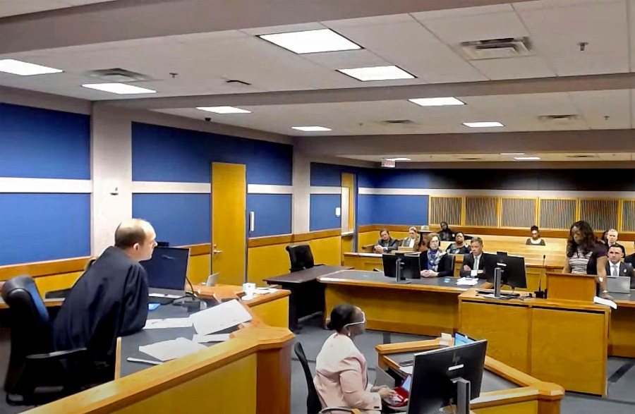 In this frame grab from video, Sidney Powell, former attorney for former President Donald Trump, attends a hearing with her attorney Brian Rafferty before Judge Scott McAfee on Thursday, Oct. 19, 2023 at the Fulton County Courthouse in Atlanta. Powell pleaded guilty in the Georgia election interference case and was sentenced to six years probation, a fine, and she will be required to testify in future trials. (Fulton County Court/Pool Photo via AP)