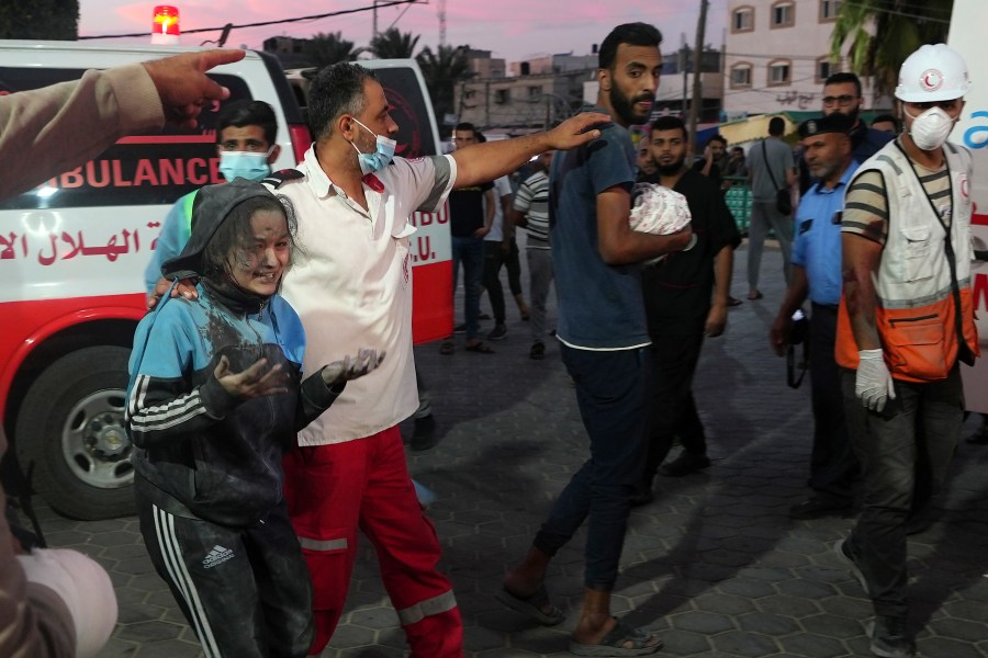 A man brings his baby killed in Israeli bombardment to Al Asa Hospital in Deir el-Balah City, Gaza Strip, Saturday, Oct. 21, 2023. (AP Photo/Adel Hana)