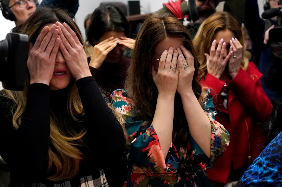 Members of the Chabad of Evanston, Ill., where Judith Raanan attended, cover their eyes as they pray at the beginning of Shabbat on Friday, Oct. 20, 2023, in Evanston. Raanan and her daughter Natalie were released Friday from their captivity in Gaza. (AP Photo/Charles Rex Arbogast)