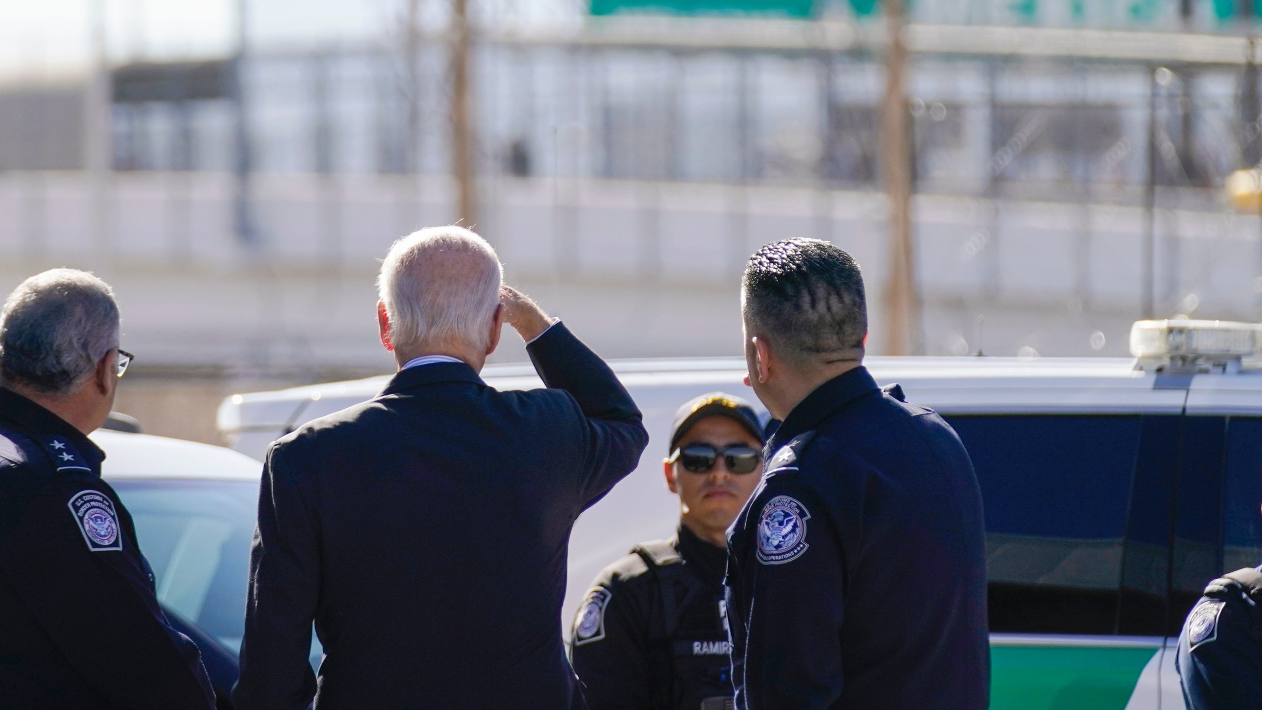 FILE - President Joe Biden, second from left, looks towards a large "Welcome to Mexico" sign that is hung over the Bridge of the Americas as he tours the El Paso port of entry, a busy port of entry along the U.S.-Mexico border, in El Paso Texas, Sunday, Jan. 8, 2023. (AP Photo/Andrew Harnik, File)